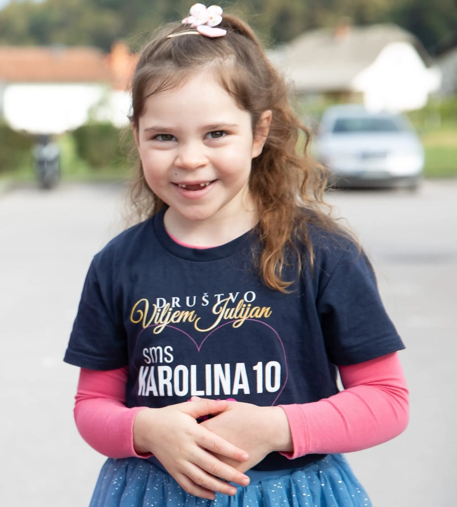 Karolina in a Viljem Julijan Association T-shirt with the SMS donation keyword for her campaign